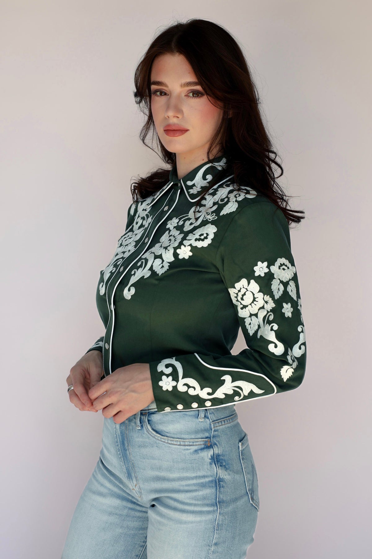 Woman in green shirt with floral embroidery