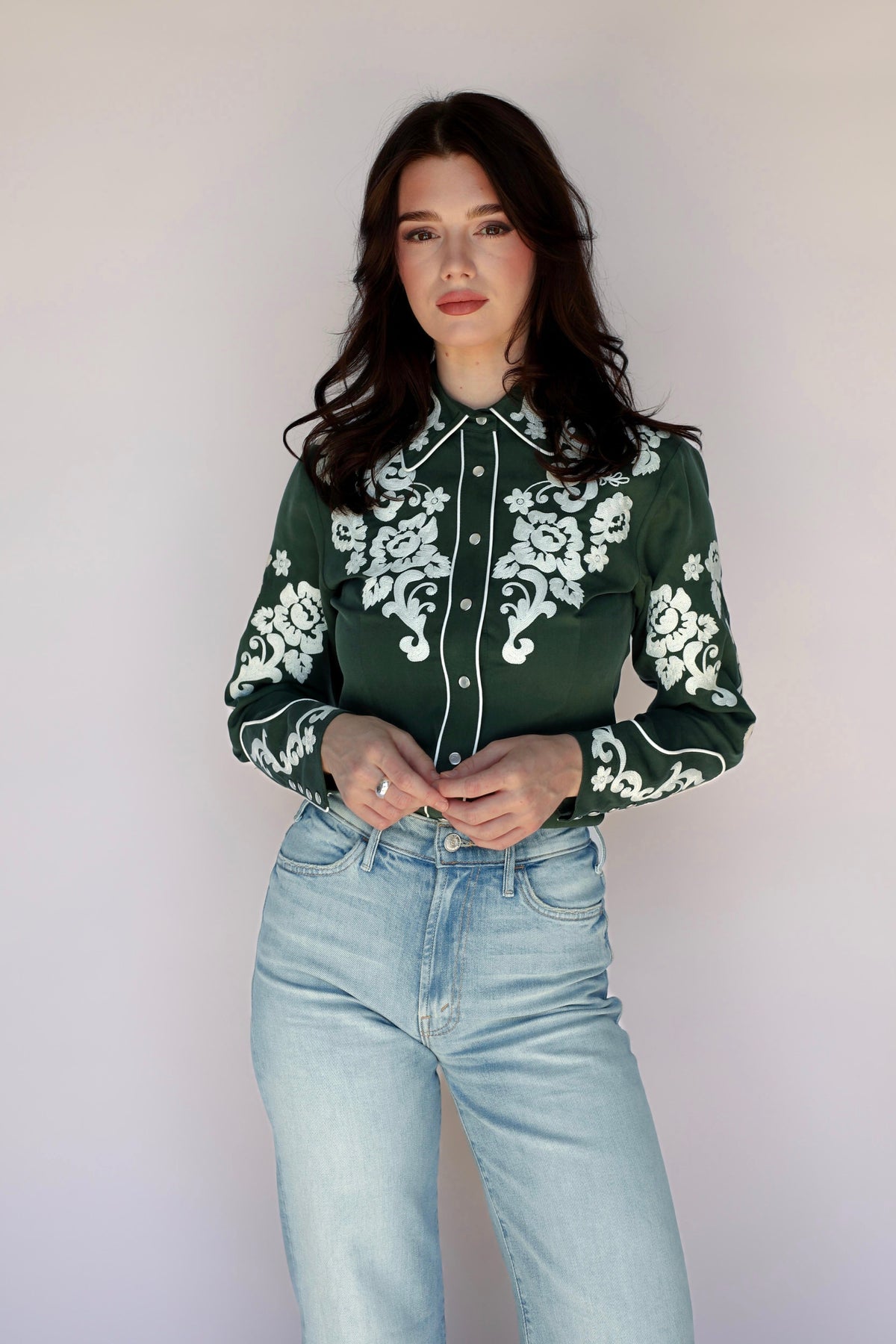 Woman in green shirt with floral embroidery