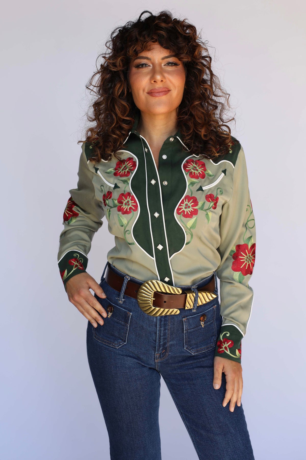 Woman wearing the H Bar C Santa Ana women's western shirt in sage green with a forest green contrast yoke, red floral embroidery, and white piping, vintage inspired western wear.