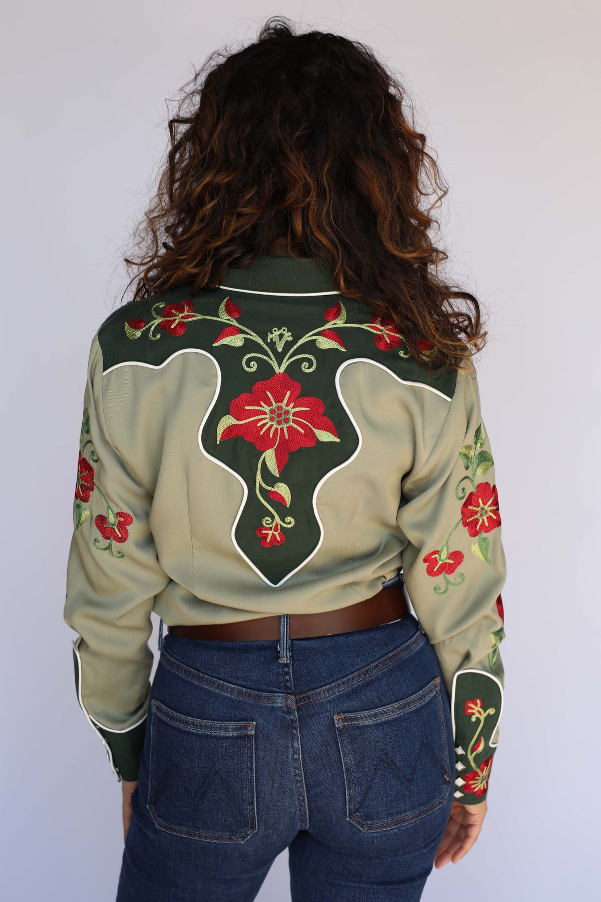 Back yoke of the H Bar C Santa Ana sage green shirt with red flower embroidery and white piping, vintage western wear for women.