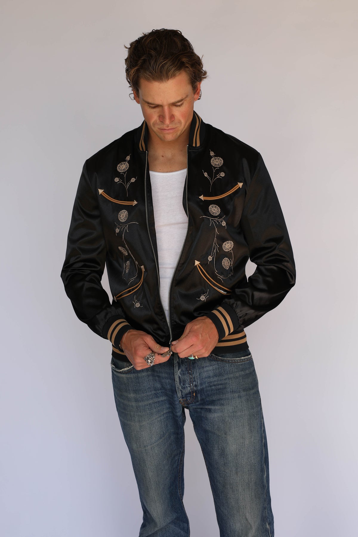 H Bar C x Gibson Odessa unisex jacket in black satin with silver zipper and tan striped ribbing, vintage inspired western wear.