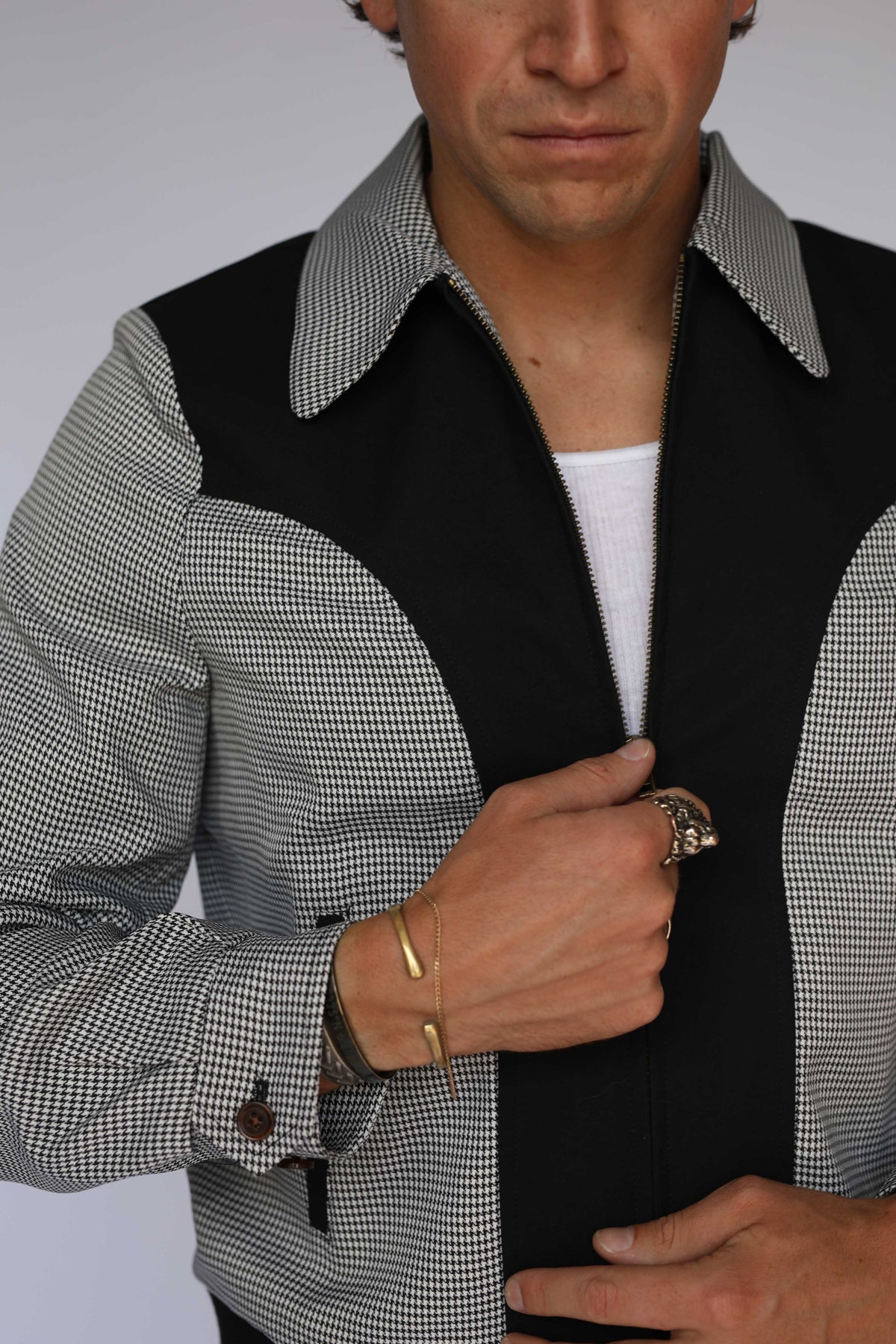 H Bar C Kentucky jacket in black houndstooth with black suede western yoke, zip front, and ribbed waistband, worn by a model