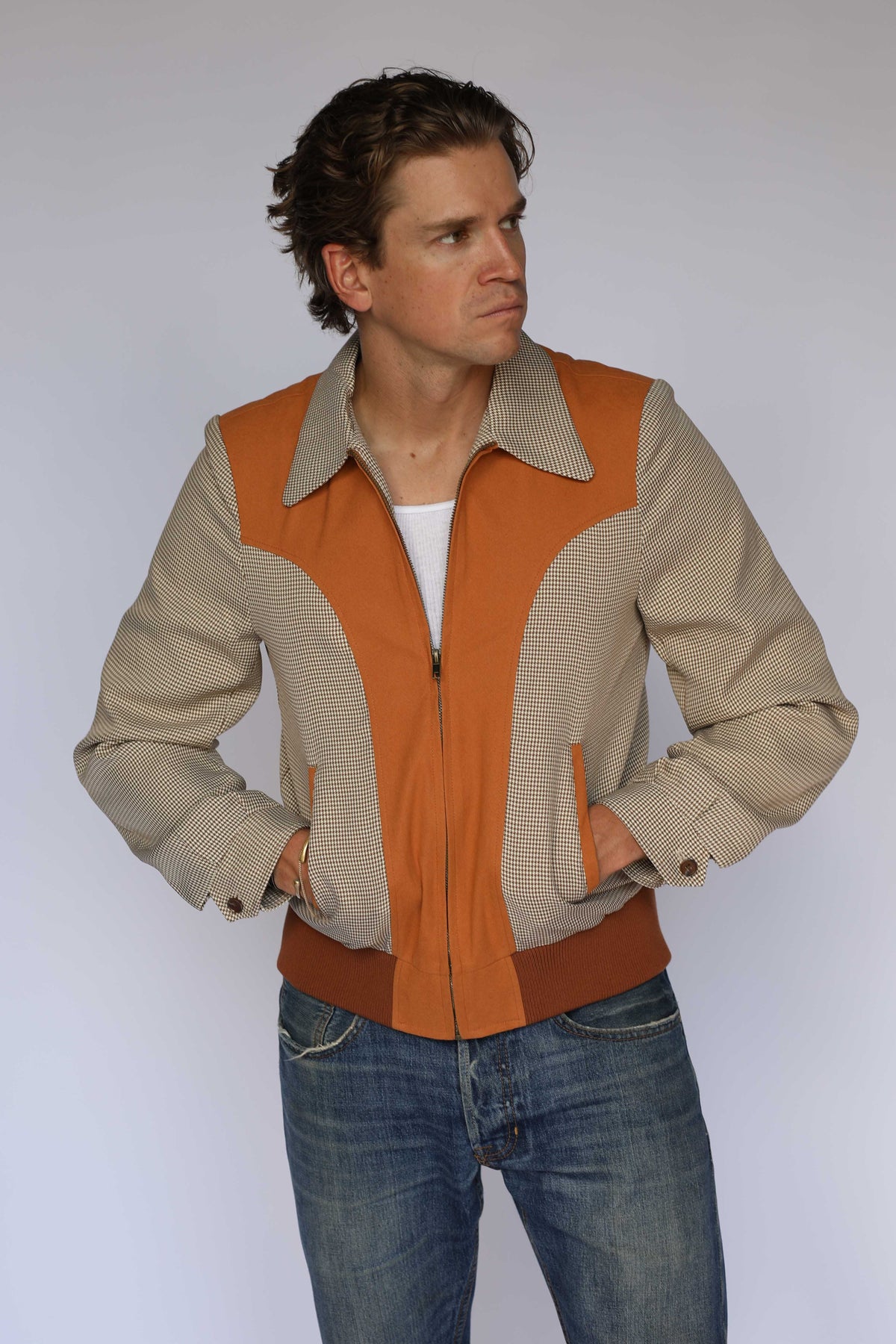 H Bar C Kentucky jacket in brown houndstooth with rust suede western yoke, zip front, and ribbed waistband, worn by a model
