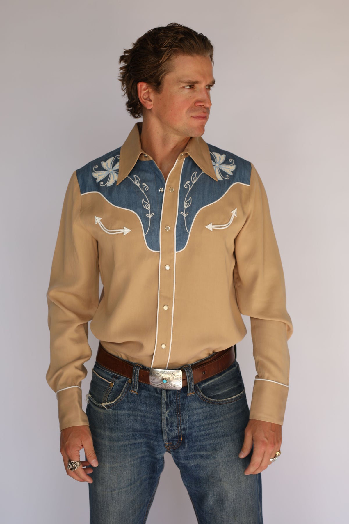H Bar C Telluride tan and denim western shirt with white smile piping and pearl snap placket, vintage inspired western wear worn with blue jeans.