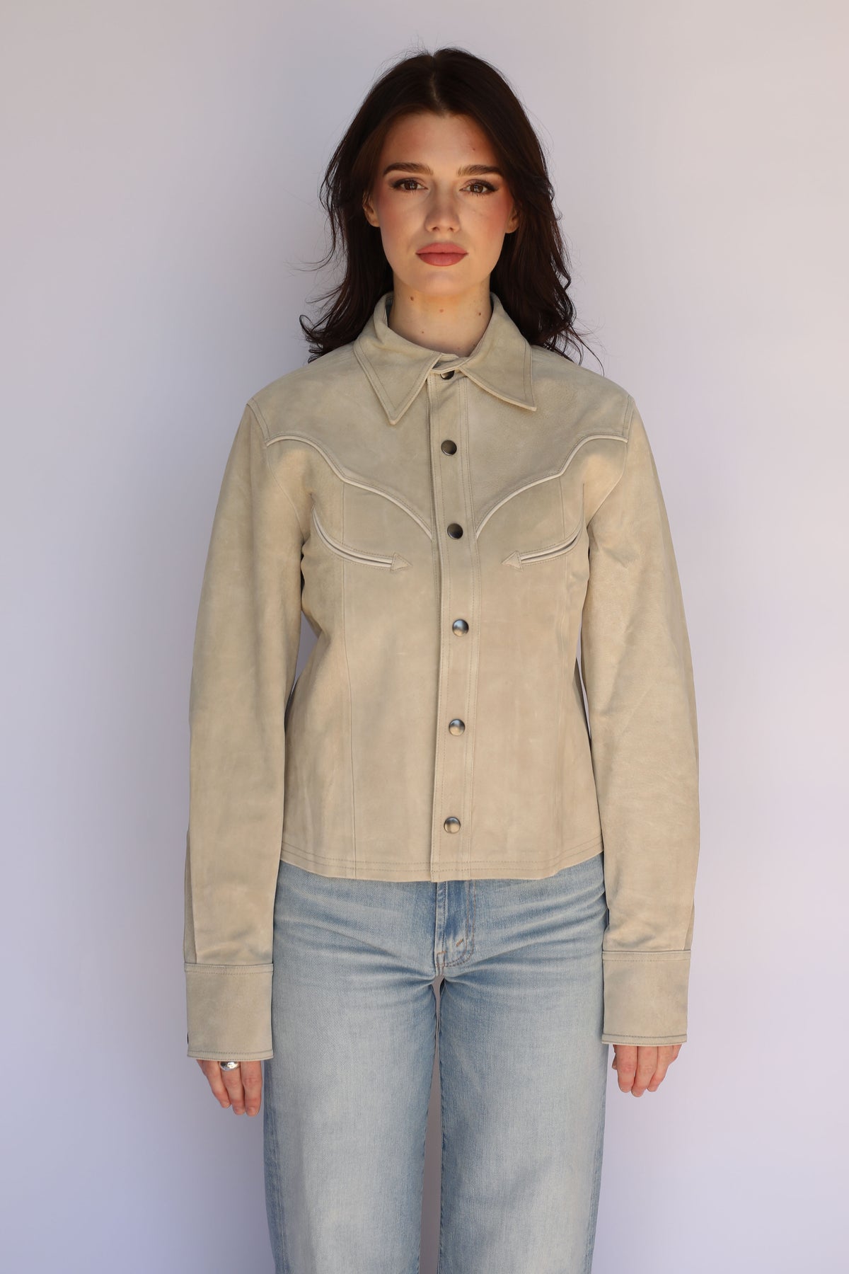 Woman wearing the H Bar C Austin jacket in stone with light jeans, a unisex western jacket styled as women's vintage inspired western wear.