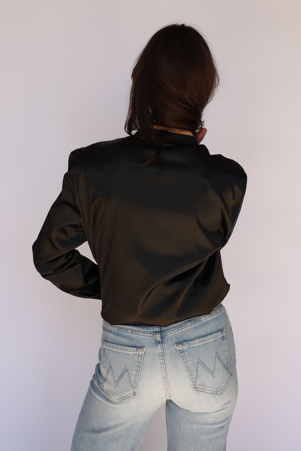 Woman wearing the H Bar C x Gibson J-200 Odessa Unisex Jacket in black satin, vintage inspired western wear