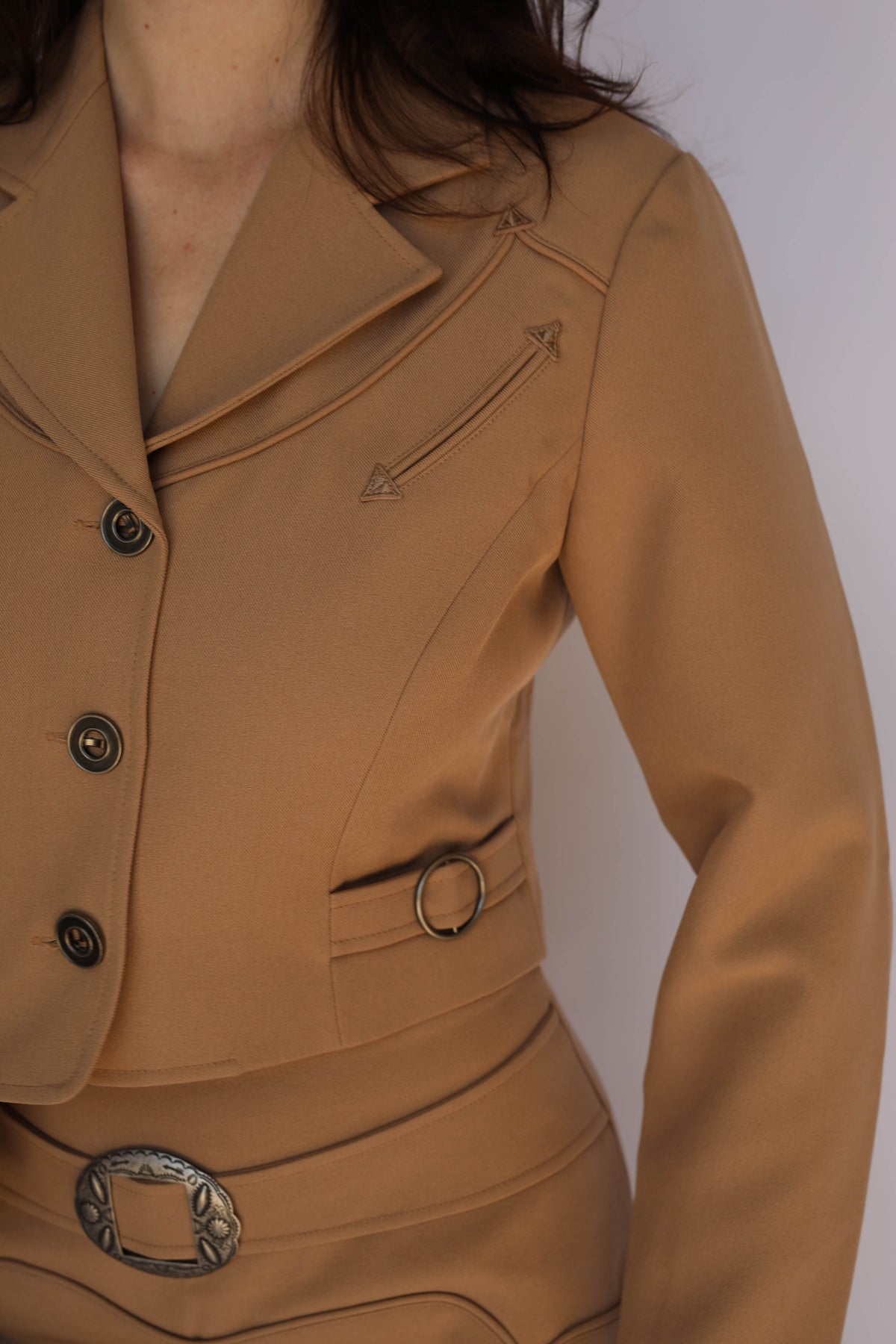 Detail of the H Bar C Raleigh tan western jacket with snap buttons and side O-ring tab, vintage western wear.