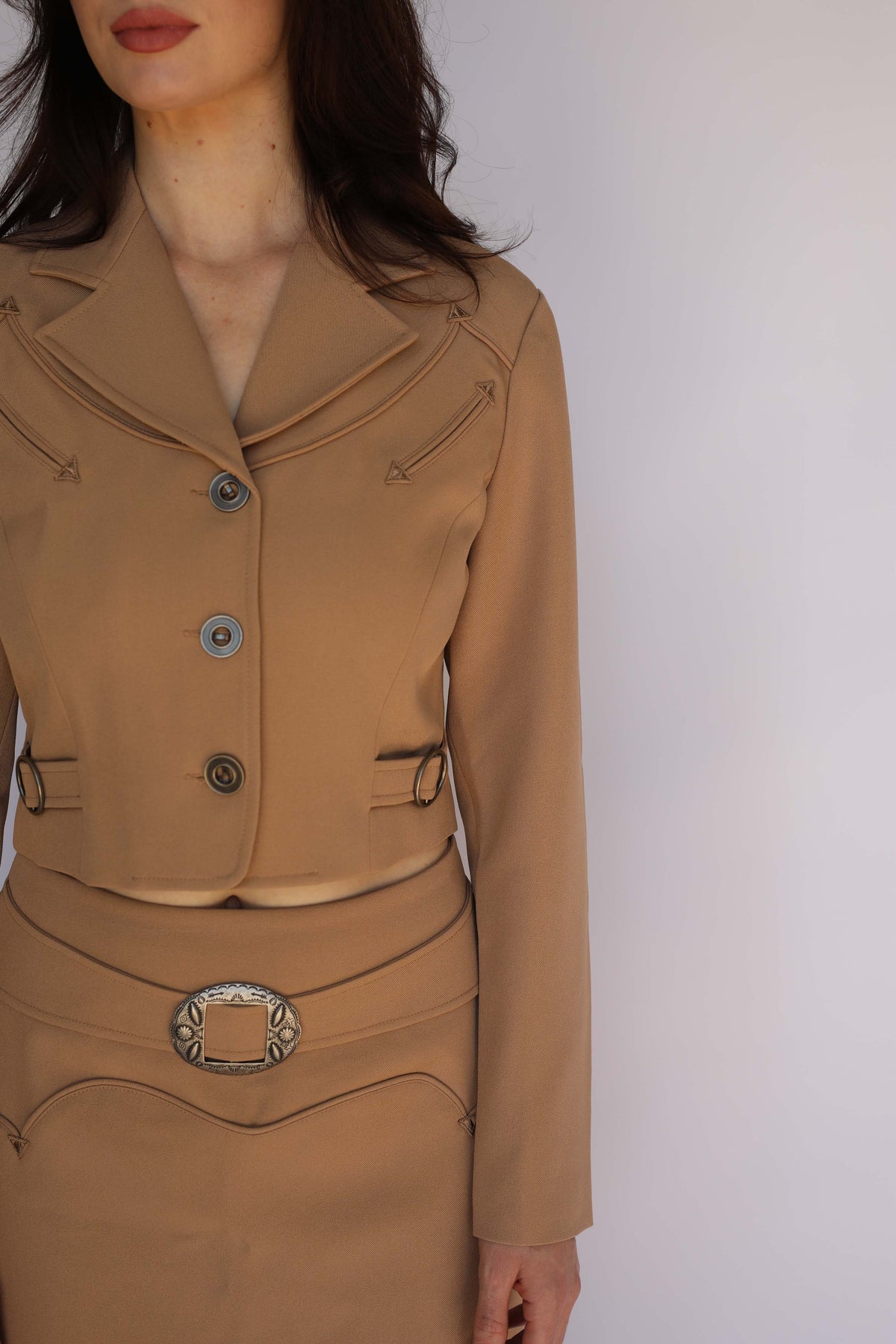Model in the H Bar C Raleigh tan jacket and skirt set, 1970s style vintage western wear.