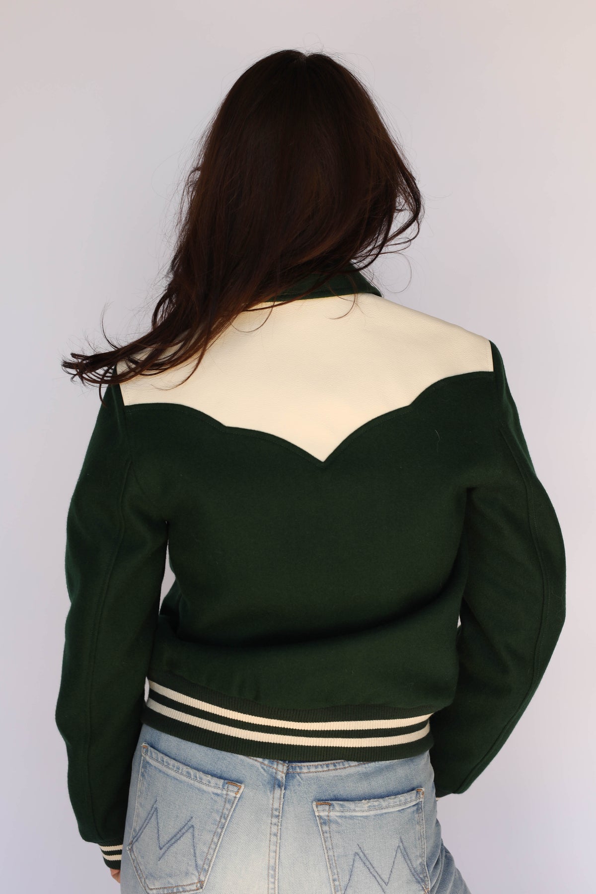 Woman wearing the Vail Unisex Jacket in green