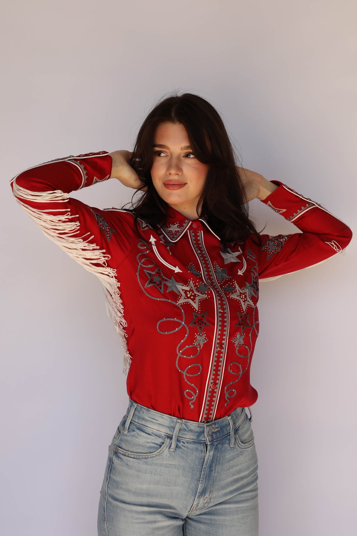 Woman in the H Bar C Las Vegas red western shirt with star chain stitch and rhinestones, showstopping vintage western wear.