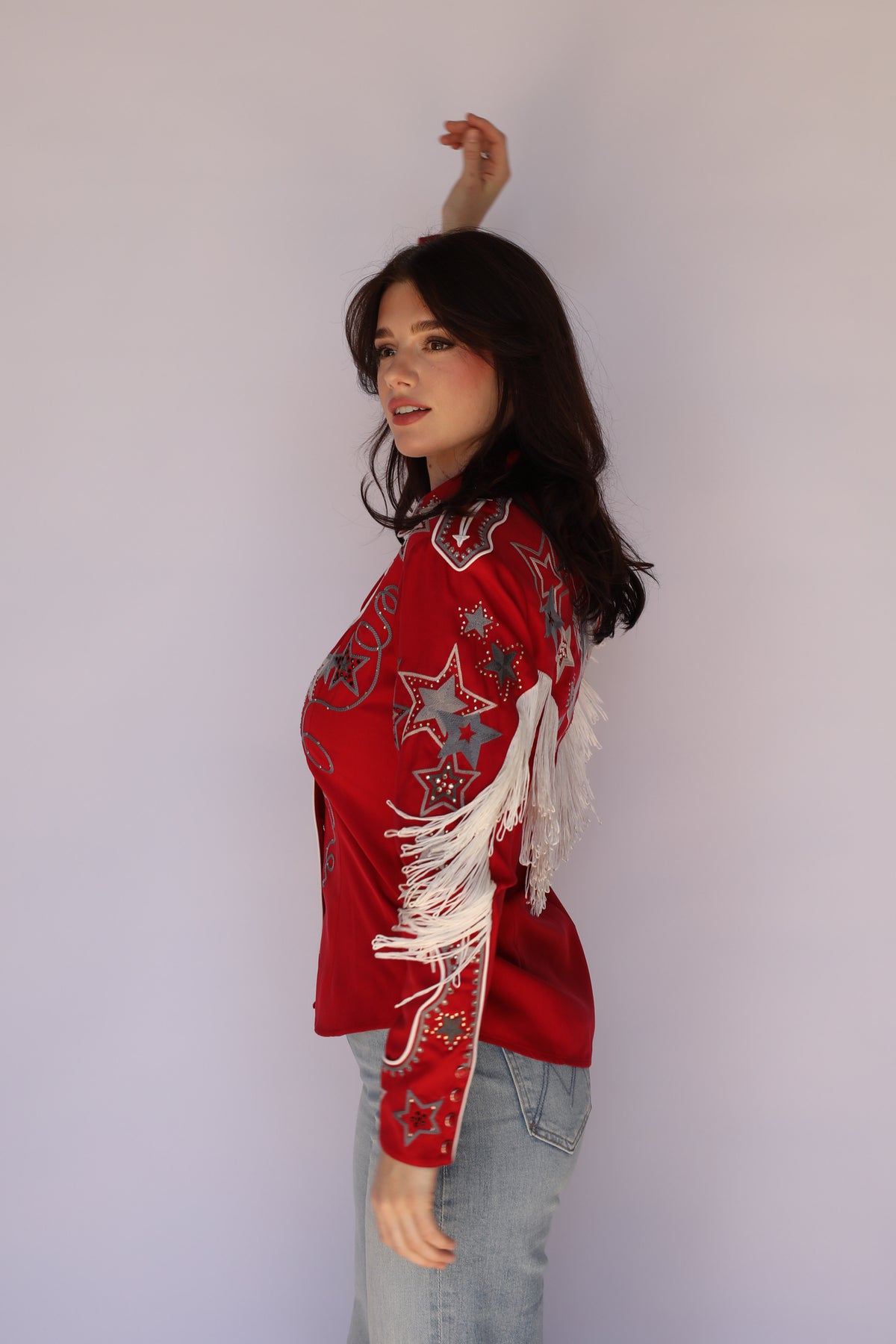 Side view of the H Bar C Las Vegas red shirt showing fringe and star embroidery, vintage inspired western wear.
