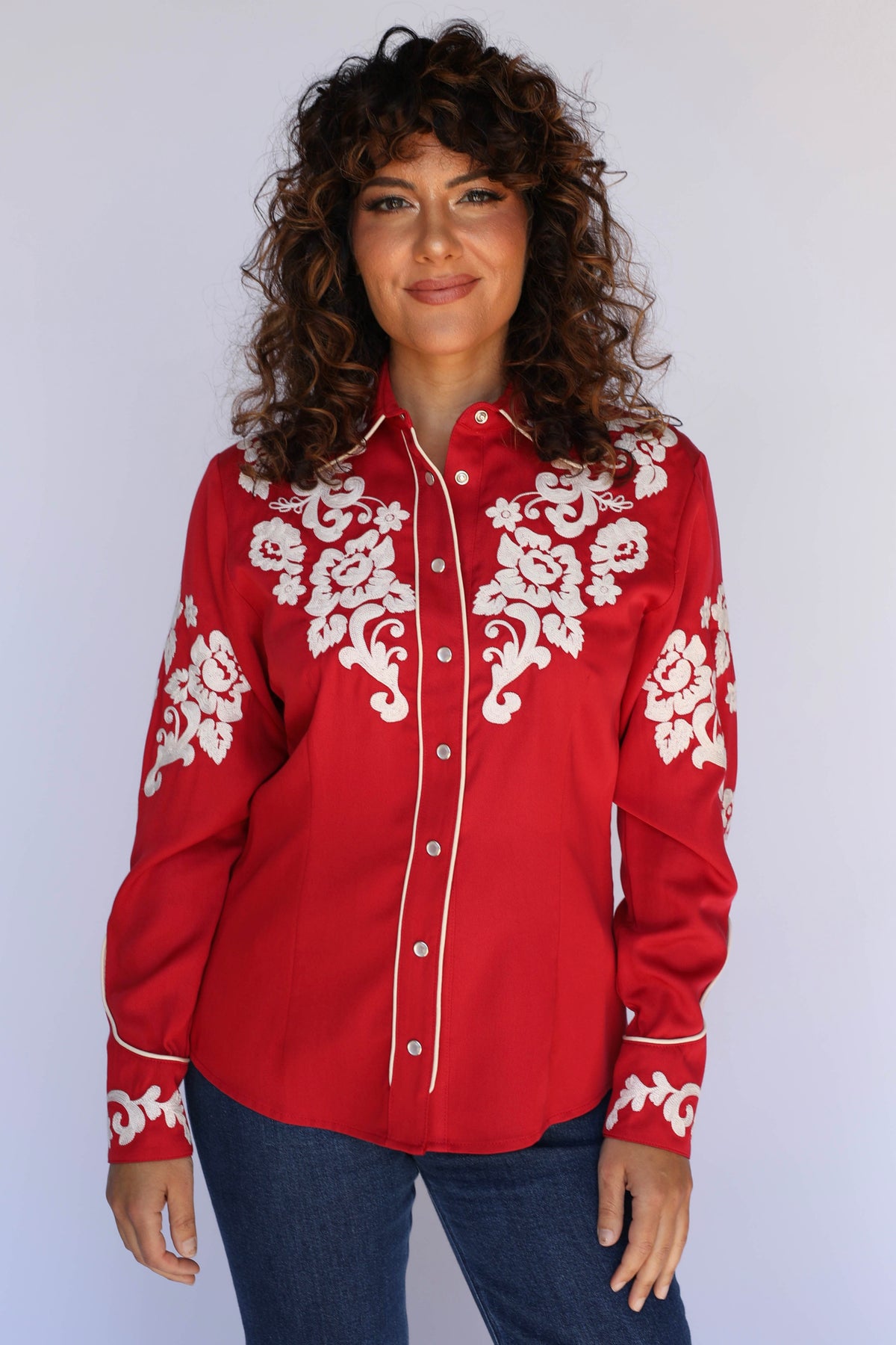 Model in the H Bar C Fort Worth red western shirt with ornate cream floral embroidery, classic vintage western wear for women.