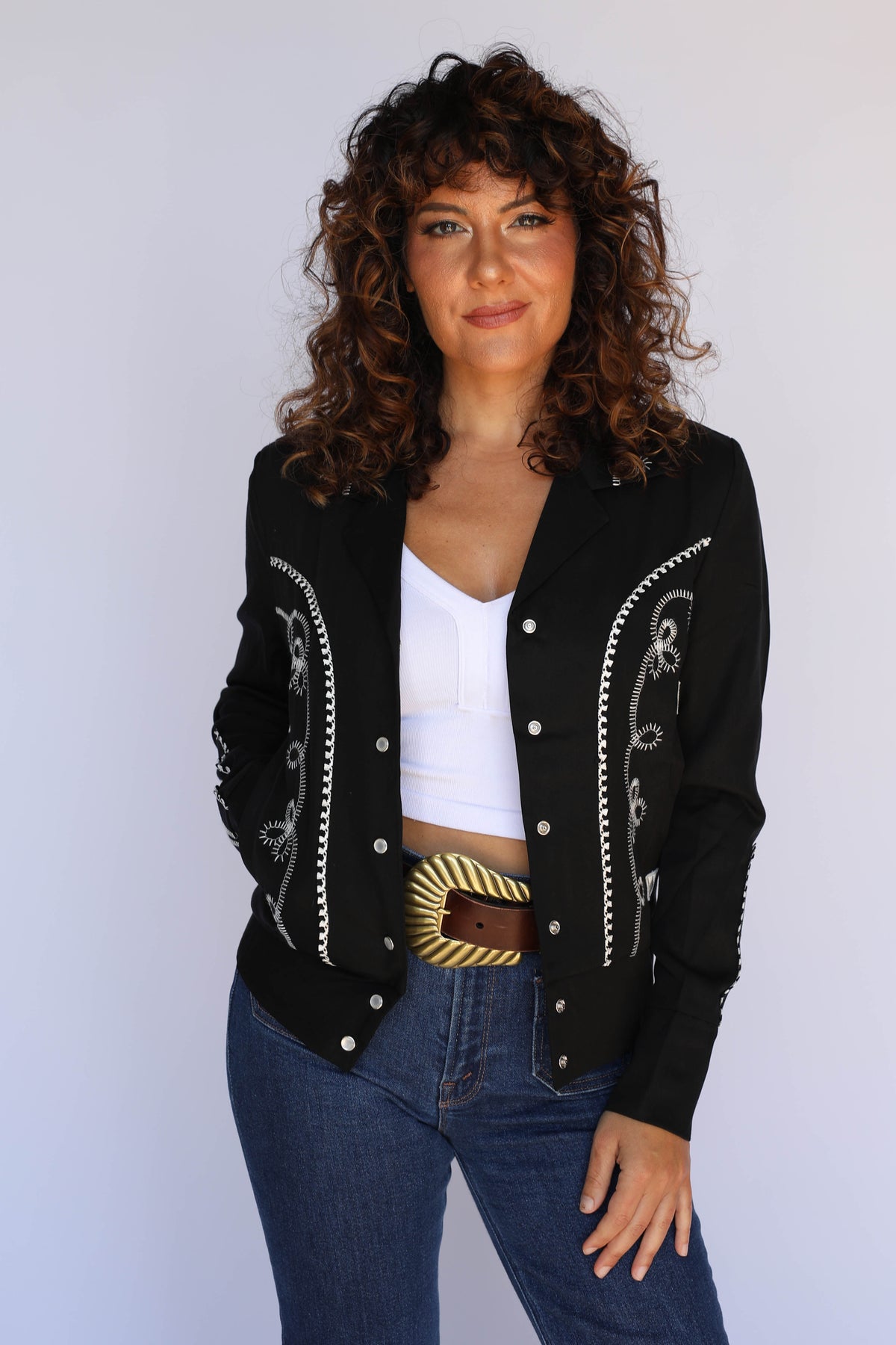 Front view of the H Bar C Bolero black cropped western jacket for women with contrast white trim.