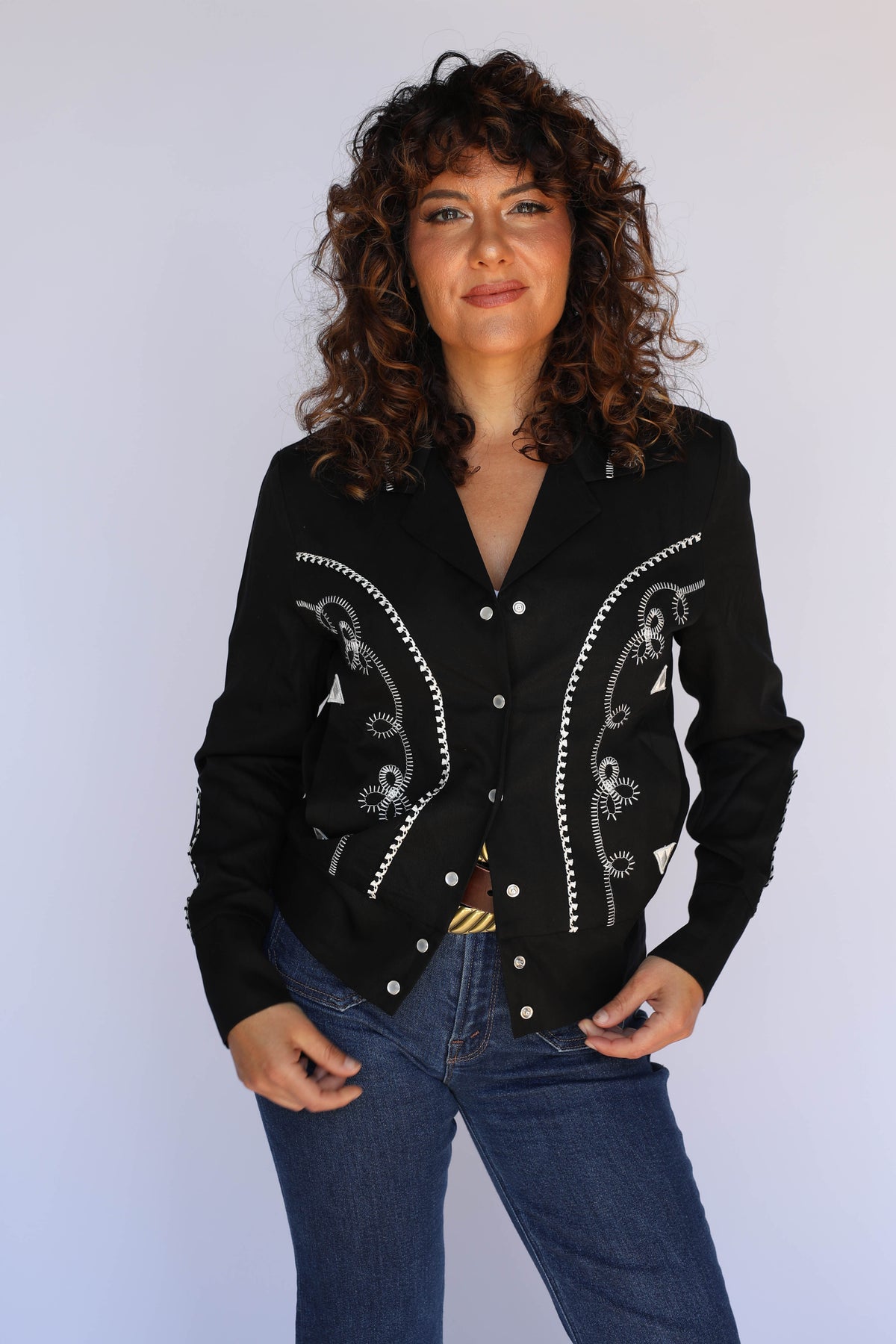 Woman with hands in pockets wearing the H Bar C Bolero black and white women's cropped western jacket.