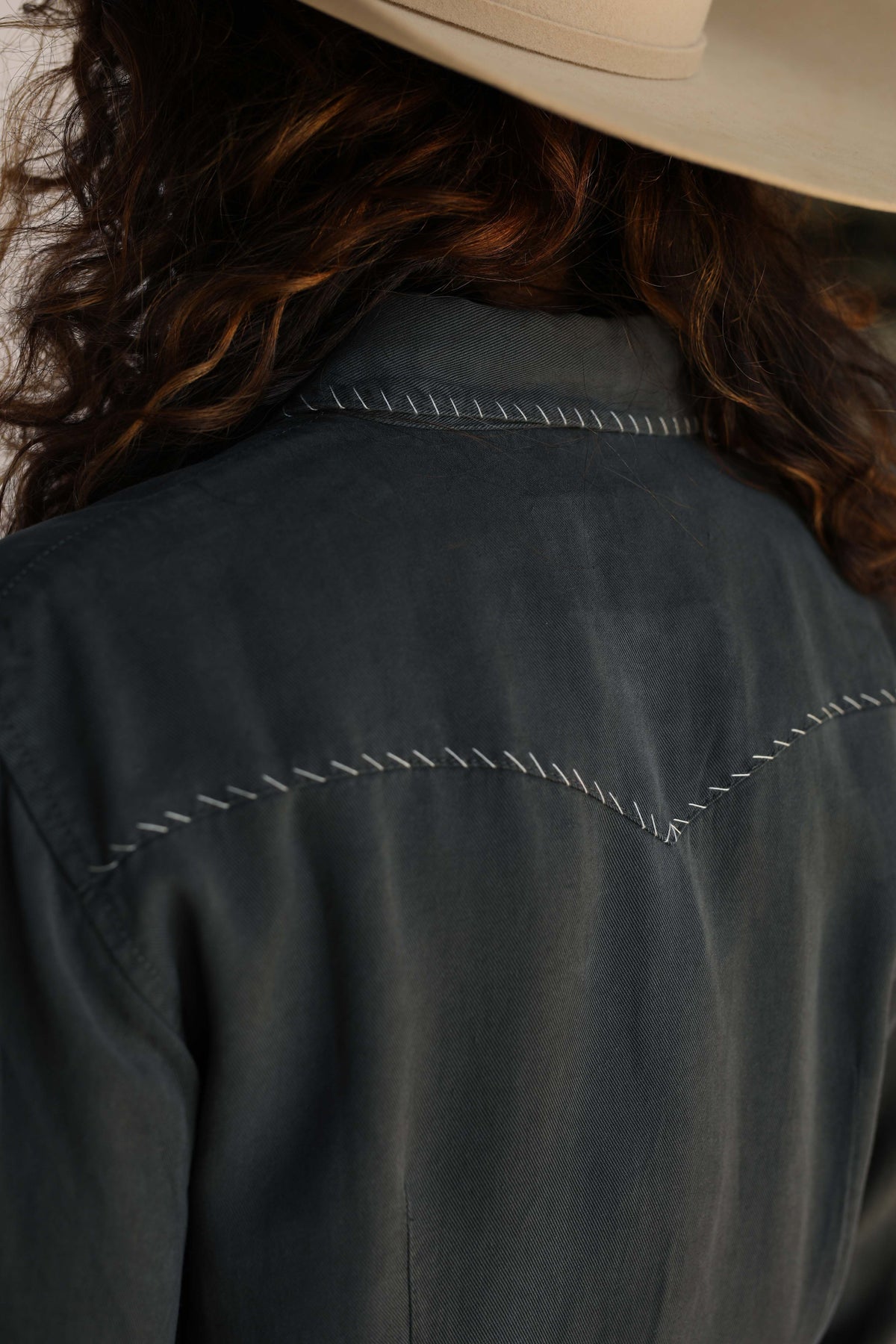 Woman in charcoal shirt