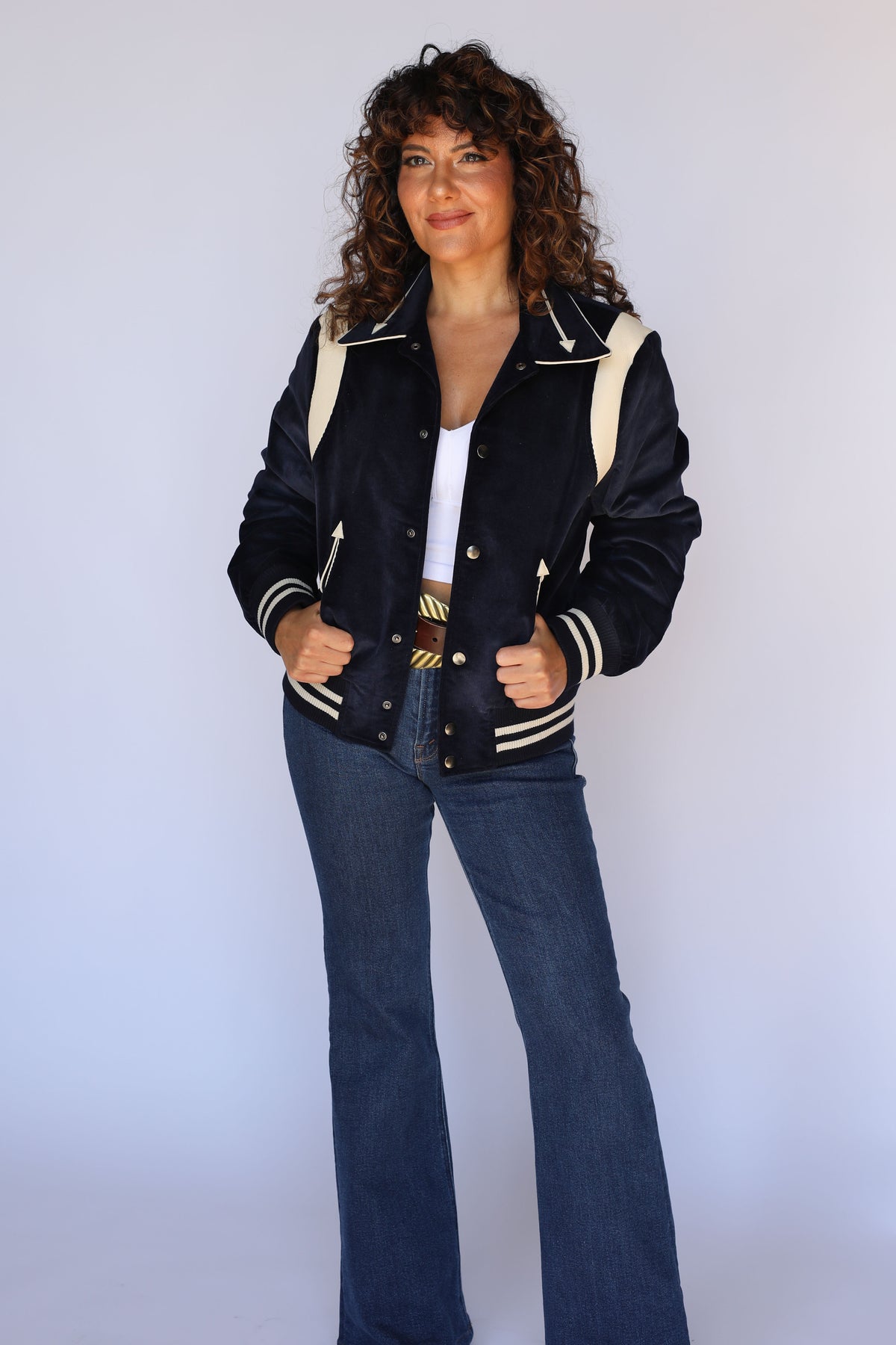 Woman wearing the H Bar C Silver Lake unisex corduroy jacket in navy with cream lambskin shoulder panels, women's vintage inspired western wear.