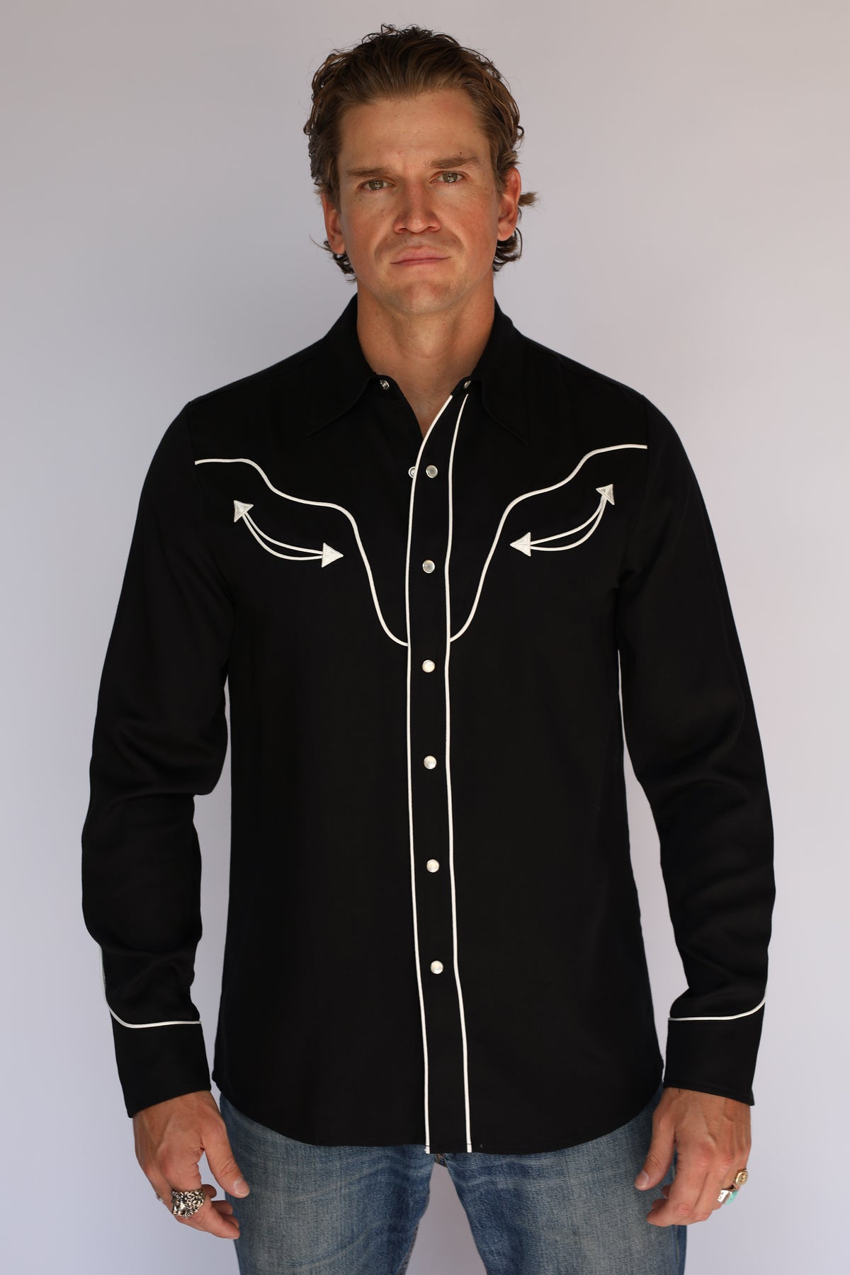 Full front view of the H Bar C San Fernando men's black shirt worn with jeans, classic vintage western wear with white piping.