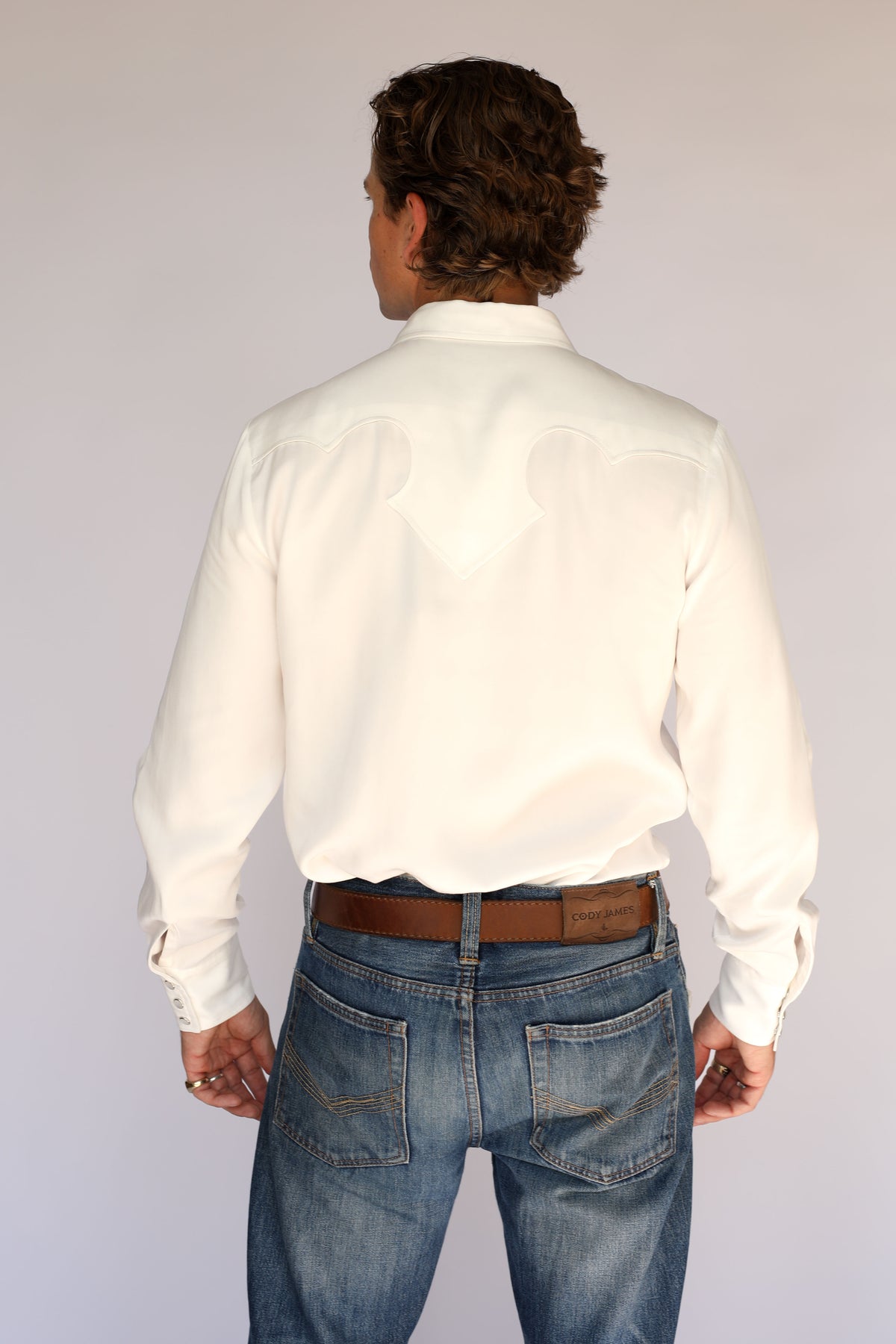 Model wearing the H Bar C El Segundo white western shirt, a men's pearl snap shirt from the H Bar C archive.