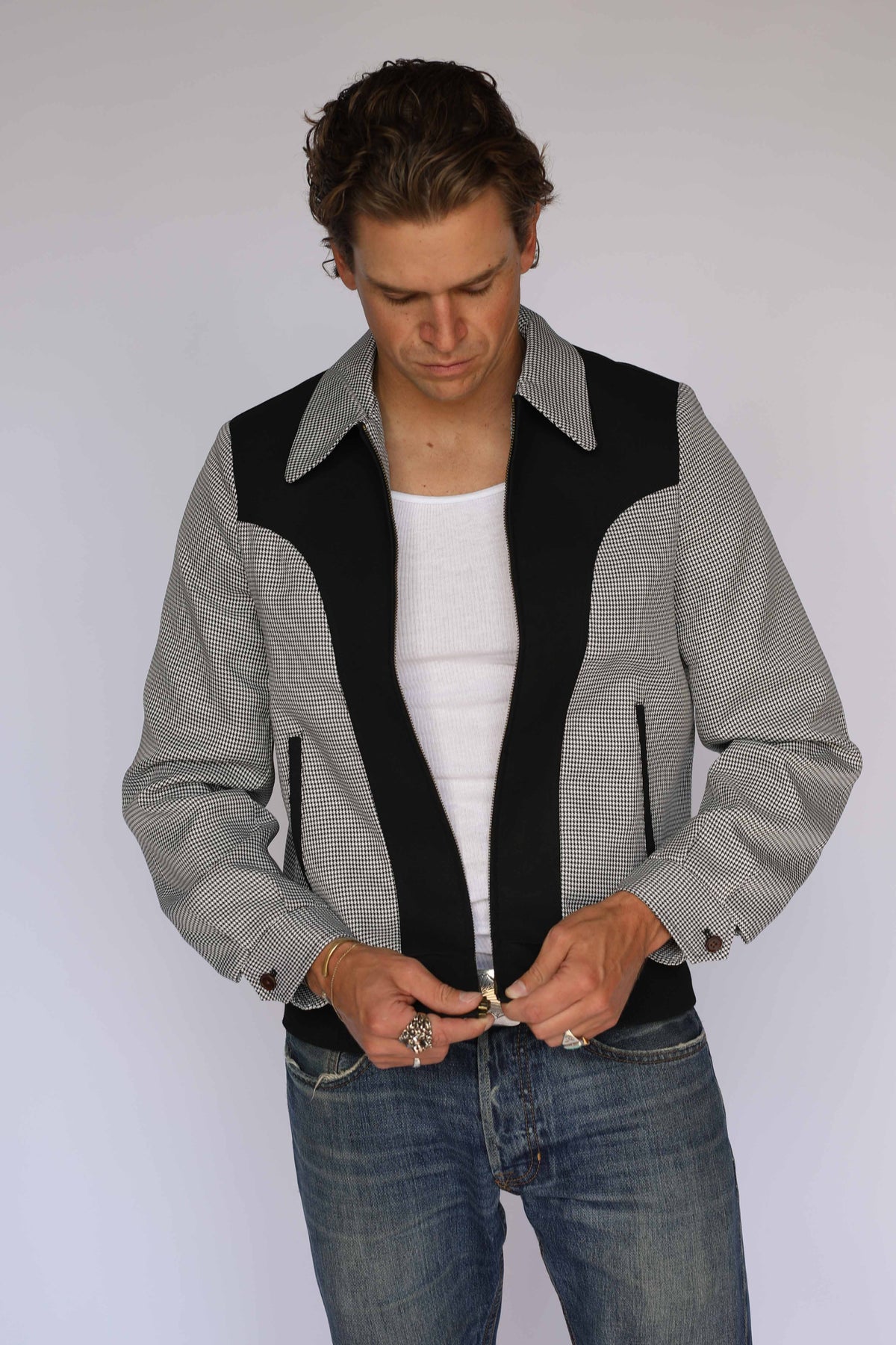 H Bar C Kentucky jacket in brown houndstooth with rust suede western yoke, zip front, and ribbed waistband, worn by a model