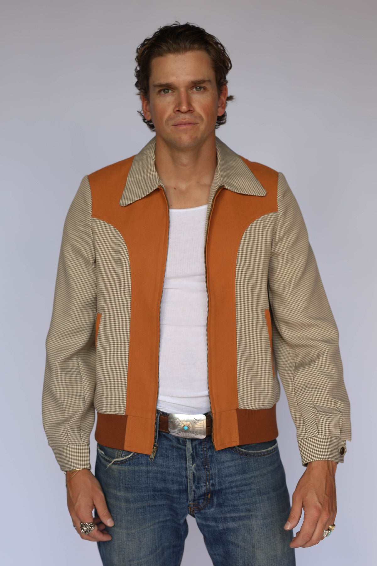 H Bar C Kentucky jacket in brown houndstooth with rust suede western yoke, zip front, and ribbed waistband, worn by a model