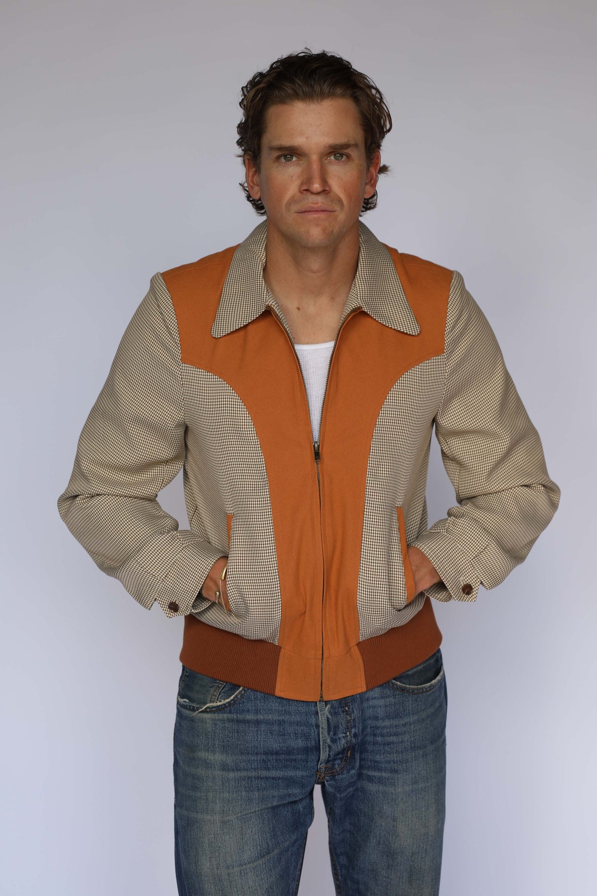 H Bar C Kentucky jacket in brown houndstooth with rust suede western yoke, zip front, and ribbed waistband, worn by a model