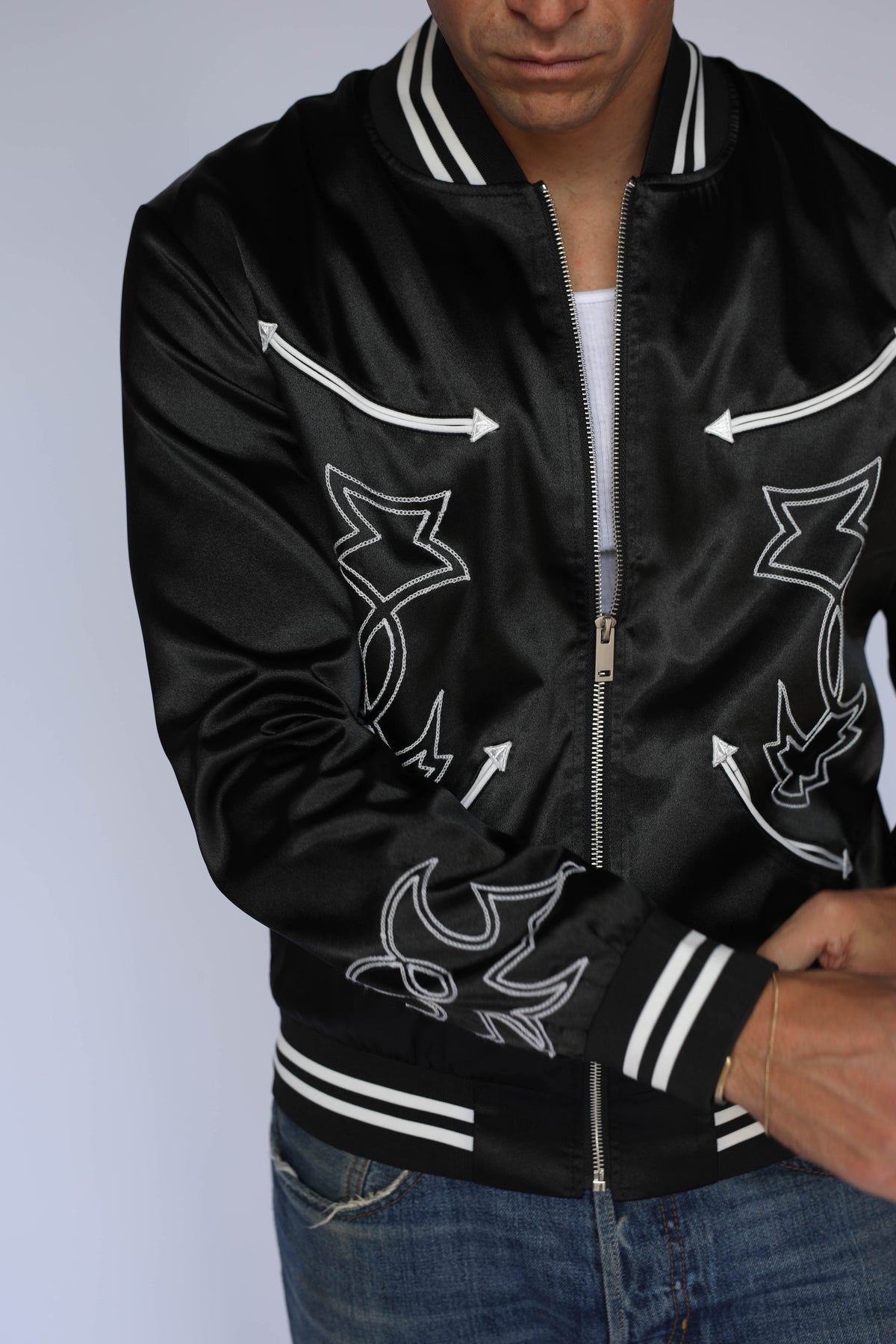Model in the H Bar C Odessa black tour jacket showing white boot stitch embroidery on the front panels, 1950s concert style vintage western wear.
