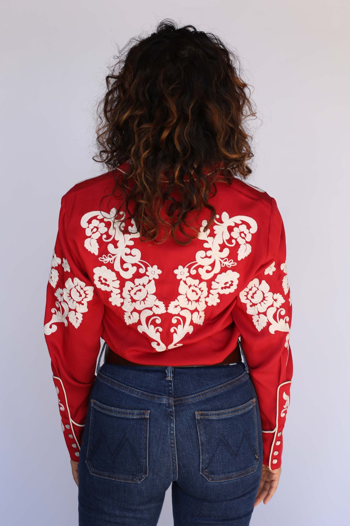 Detail of the cream chain stitch floral embroidery on the H Bar C Fort Worth women's red shirt, vintage western wear.