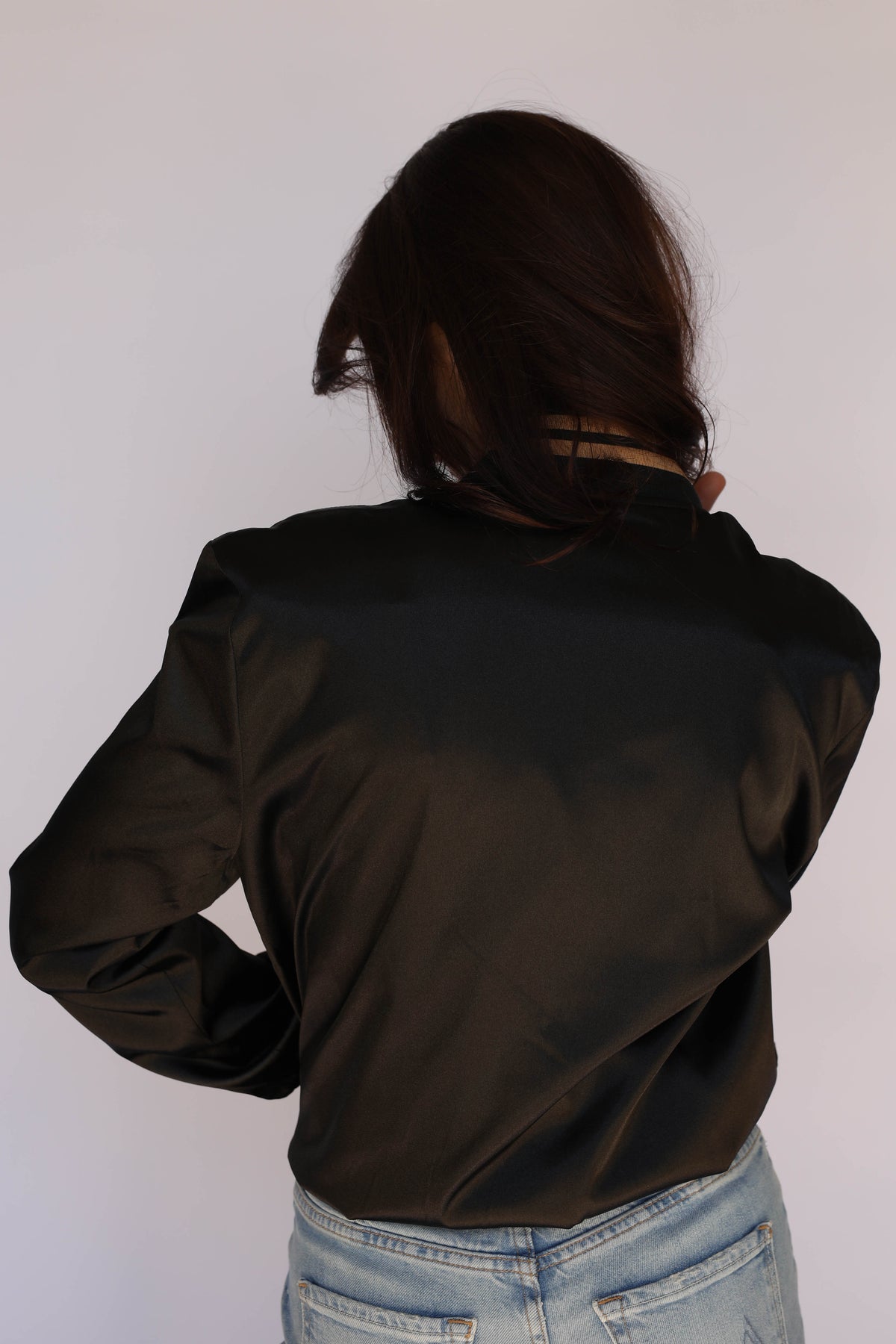 Woman wearing the H Bar C x Gibson J-200 Odessa Unisex Jacket in black satin, vintage inspired western wear