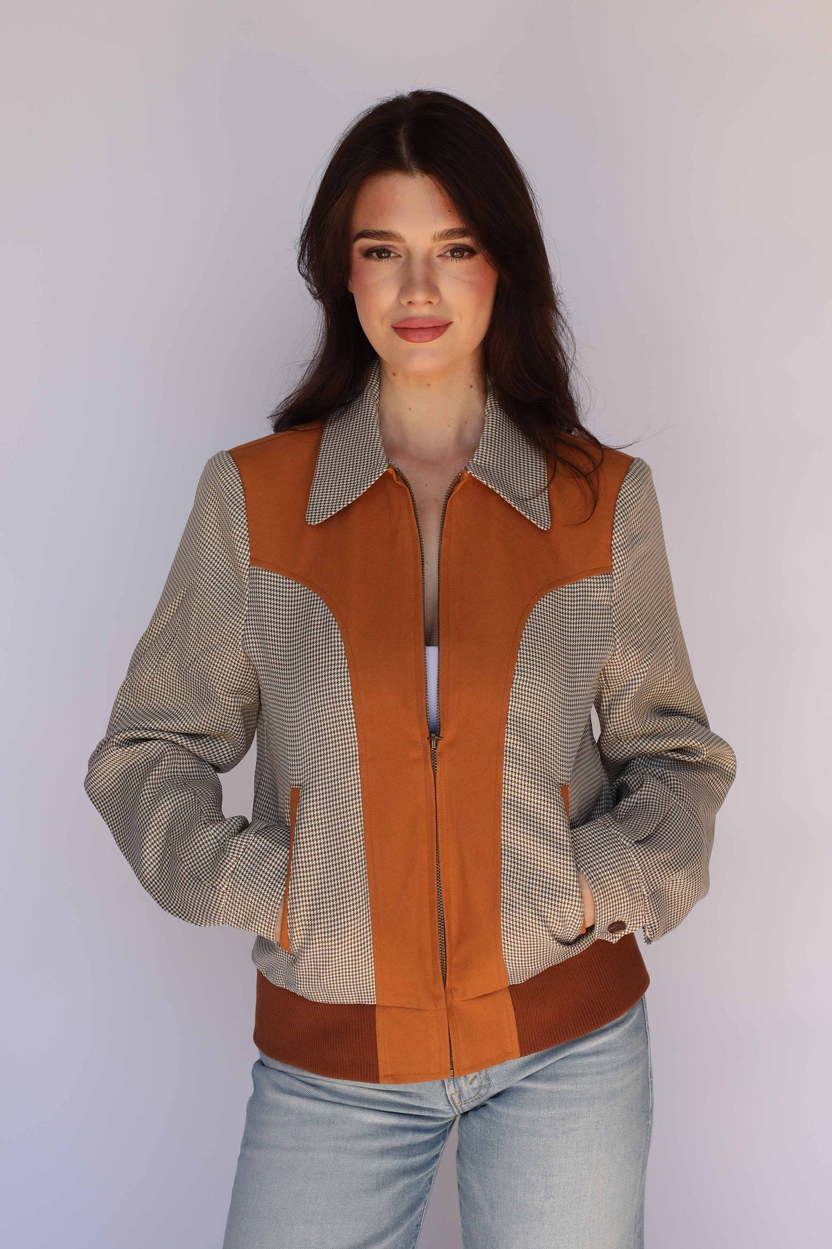 Woman wearing the H Bar C Kentucky unisex jacket in brown with a contrast western yoke, styled with light jeans as women's vintage inspired western wear.
