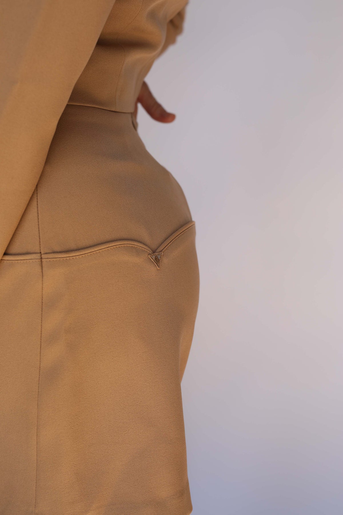 Close-up of the H Bar C Raleigh tan skirt showing the scalloped yoke piping and arrowhead details, vintage western wear.