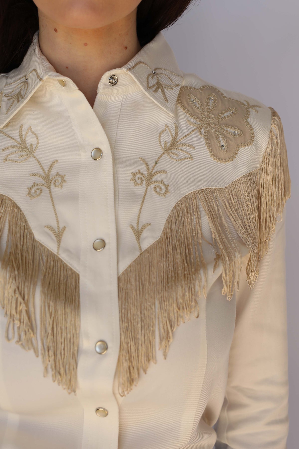 Close-up of the fringe and western yoke detail on the H Bar C Taos women's white shirt.