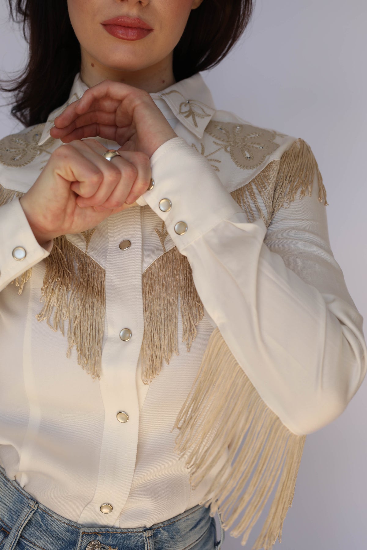 Close-up of the H Bar C Taos white fringe shirt sleeve and cuff, vintage western wear detail.