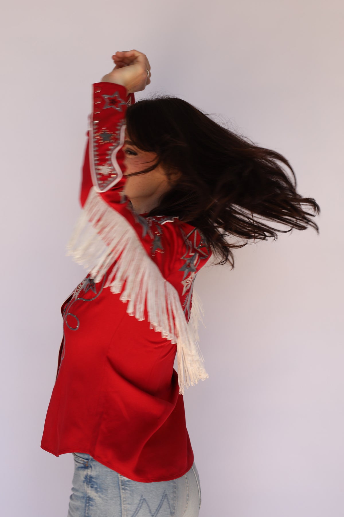 Model moving in the H Bar C Las Vegas red fringe western shirt, vintage western wear for women.