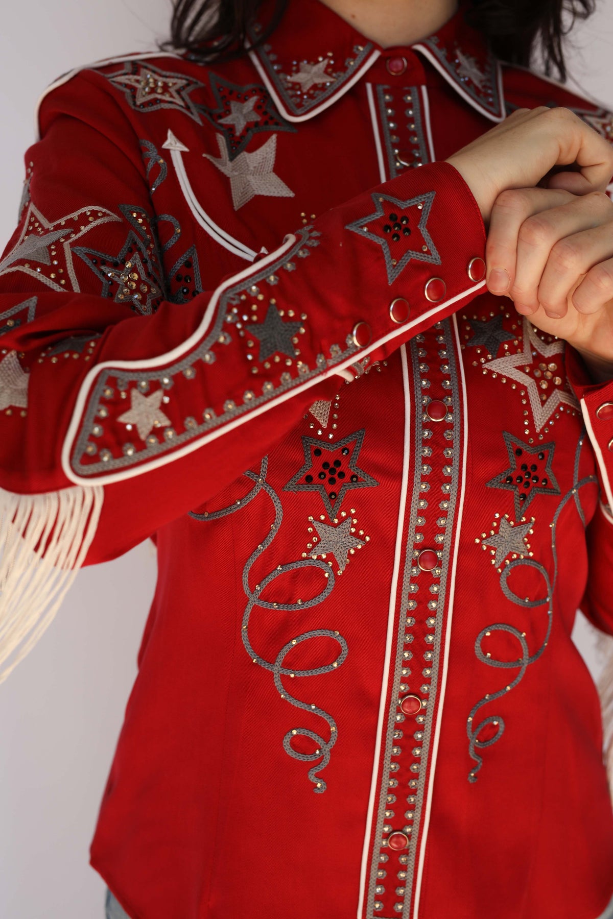 Close-up of the sleeve fringe and studded star embroidery on the H Bar C Las Vegas red western shirt, vintage western wear.