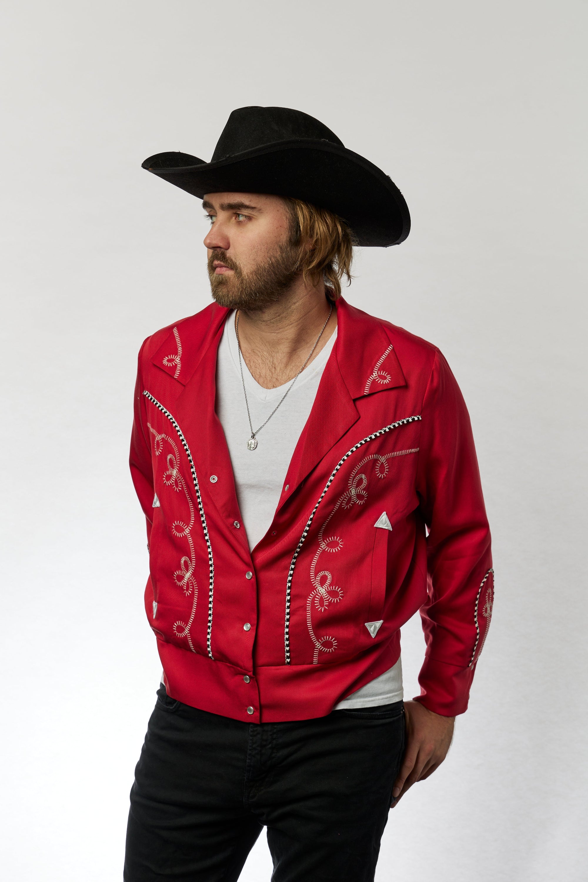 Man in red jacket with white embroidery